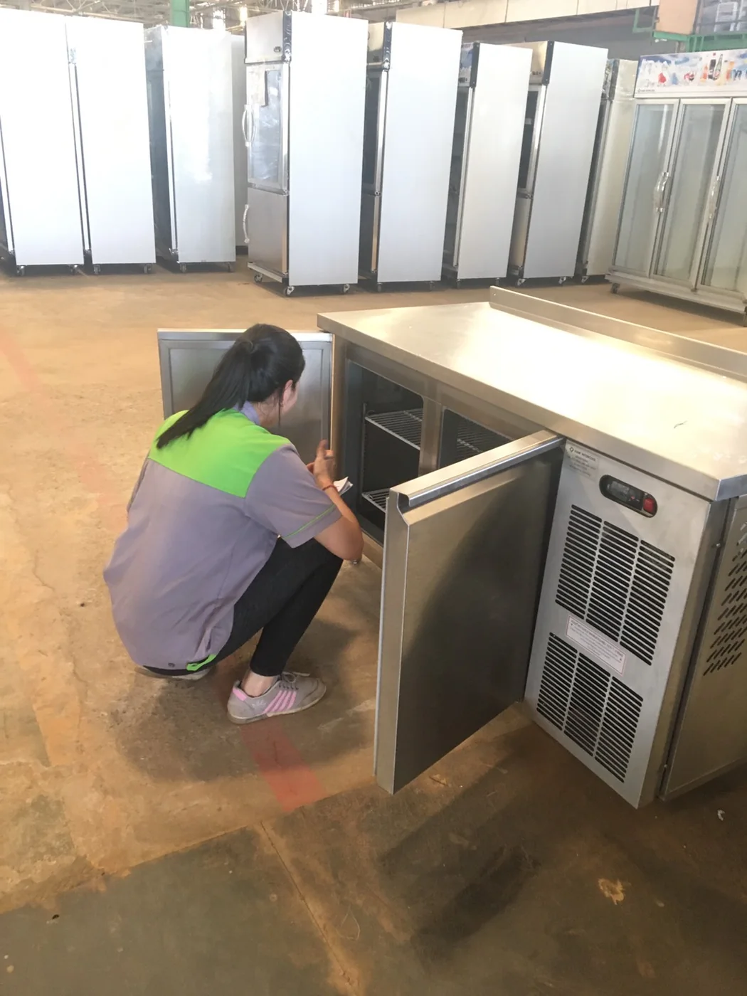 Final cabinet inspection before commercial refrigerator delivery